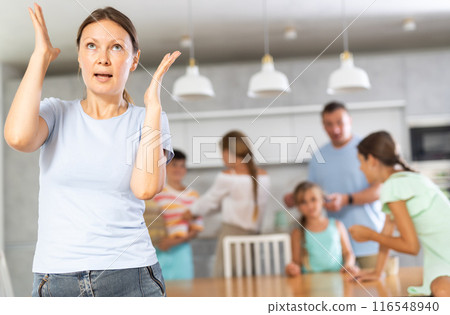 Wife is enraged by family conflict of teenage daughters with their father. 116548940