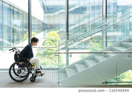 A woman in a wheelchair having trouble with the steps 116548949