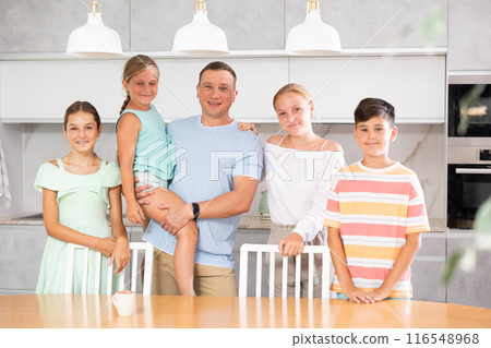 Portrait of best dad who spends his free time with cute, adorable kids in bright modern home kitchen Portrait of best dad who spends his free time with cute, adorable kids in bright modern home kitchen 116548968