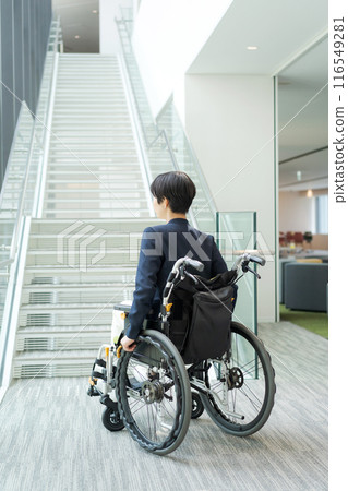 A woman in a wheelchair having trouble with the steps 116549281