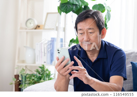 Middle-aged man looking at smartphone 116549555