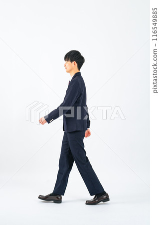 Full body photo of a male student in uniform walking Full body photo of a male student in uniform walking 116549885