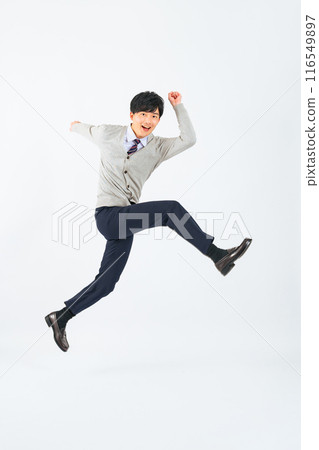 Full-body photo of a male student in uniform jumping 116549897