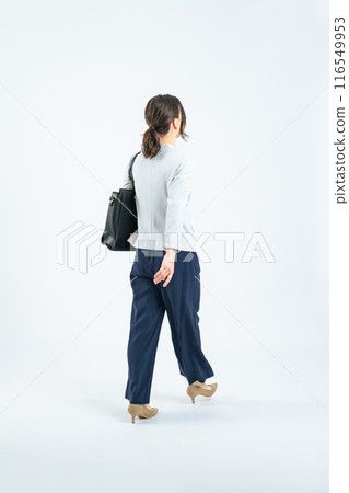 Full body photo of a walking Caucasian female business person 116549953