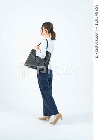 Full body photo of a walking Caucasian female business person Full body photo of a walking Caucasian female business person 116549955