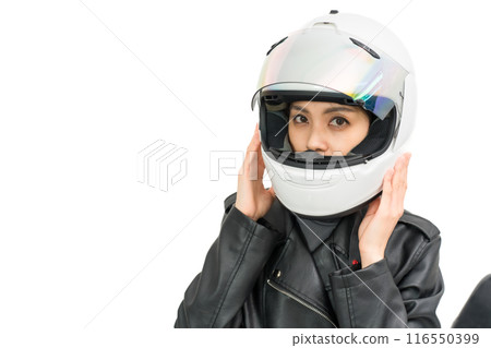 A girl riding a motorcycle wearing a full-face helmet 116550399