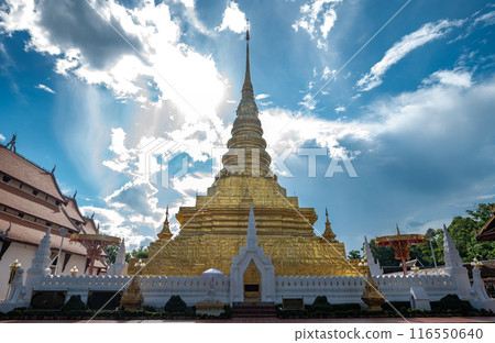 Wat Phra That Chae Hang temple with beautiful sky and clouds the most important temple in Nan province of Thailand. The chedi contains a relic of the Buddha dating back to 14th century. 116550640