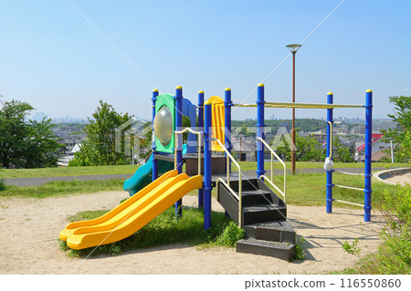 Playground equipment in a park on a hill Playground equipment in a park on a hill 116550860