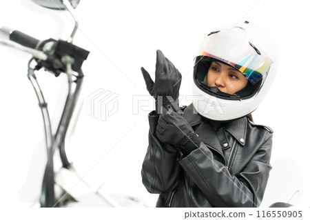 Biker girl putting on gloves 116550905