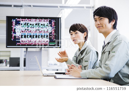 Male and female engineers having a meeting in the office Male and female engineers having a meeting in the office 116551739