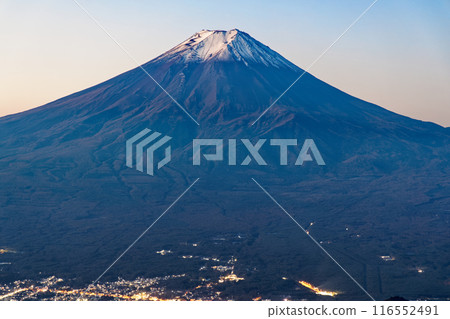 Mount Fuji and the city lights of Fujiyoshida at dawn as seen from Mitsutoge Pass Mount Fuji and the city lights of Fujiyoshida at dawn as seen from Mitsutoge Pass 116552491