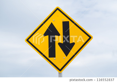 Two-way traffic ahead sign is on sky background. Two-way traffic ahead sign is on sky background. 116552837