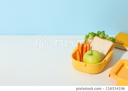 Yellow lunch box with bread, apple and carrot Yellow lunch box with bread, apple and carrot 116554196
