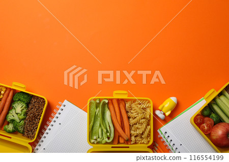 Yellow lunch box with delicious food and school supplies Yellow lunch box with delicious food and school supplies 116554199