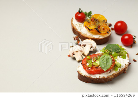 Sandwiches with grilled vegetables on a board, on a light background. Sandwiches with grilled vegetables on a board, on a light background. 116554269
