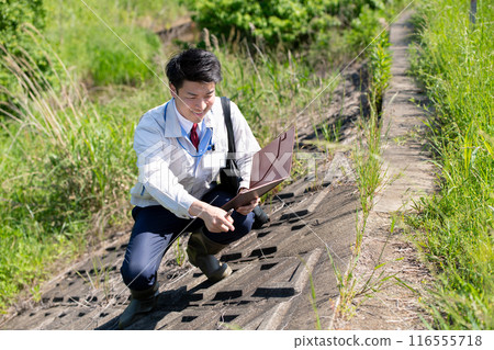 Inspecting staff Inspecting staff 116555718