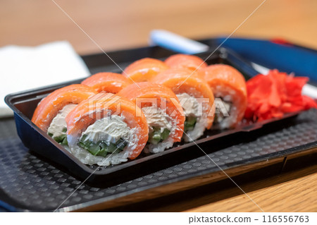 A tray of sushi served with ginger and wasabi on the side A tray of sushi served with ginger and wasabi on the side 116556763
