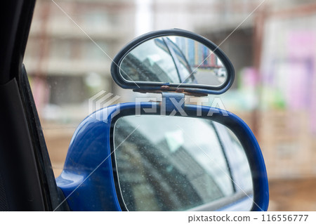 A blue car with a rear view mirror attached to it A blue car with a rear view mirror attached to it 116556777