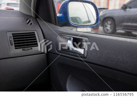 A close up photo showing a car door with a rearview mirror A close up photo showing a car door with a rearview mirror 116556795