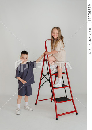 A couple of children in identical costumes have fun in the studio 116556859