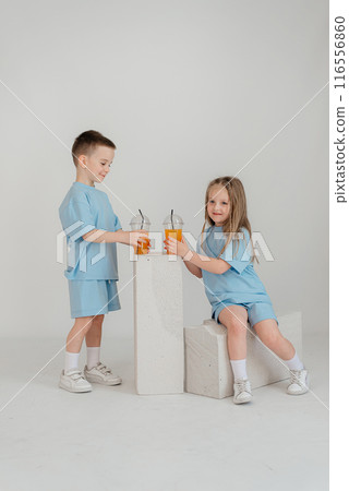 A couple of children in identical costumes have fun in the studio A couple of children in identical costumes have fun in the studio 116556860