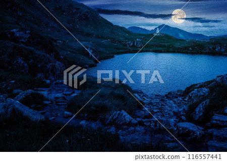 alpine lake at night. mountain landscape of transylvania alps in full moon light. composite image. mysterious scenery alpine lake at night. mountain landscape of transylvania alps in full moon light. composite image. mysterious scenery 116557441