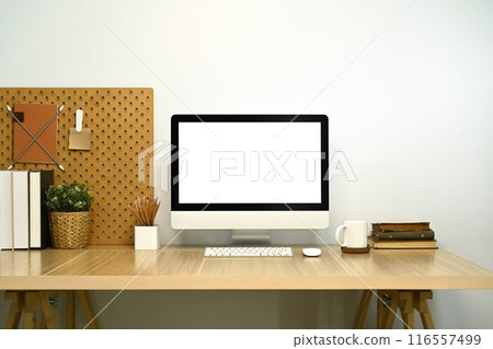 Stylish workplace. Modern desktop computer, books and houseplant on white table 116557499