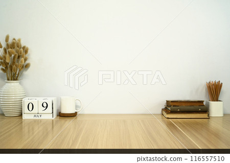 Minimalist home office setup with books, coffee cup and wooden calendar. Home decor, design inspiration content 116557510