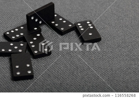 Domino knuckles on a surface covered with a coarse gray cloth. Domino knuckles on a surface covered with a coarse gray cloth. 116558268