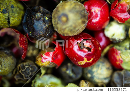 Close-up macro a vibrant mix of green, red, and black peppercorns. Close-up macro a vibrant mix of green, red, and black peppercorns. 116558371