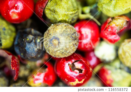 Close-up macro a vibrant mix of green, red, and black peppercorns. Close-up macro a vibrant mix of green, red, and black peppercorns. 116558372