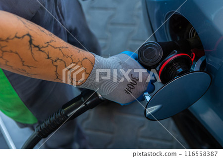 Hand Man Refill and filling Oil Gas Fuel at station. Gun petrol in the tank to fill. 116558387