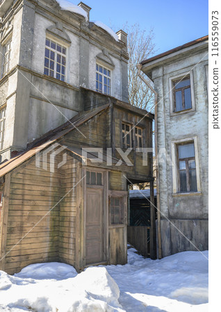 Decorations of building in Moscow, 19 century Russia with wooden door and windows, at a film studio Decorations of building in Moscow, 19 century Russia with wooden door and windows, at a film studio 116559073