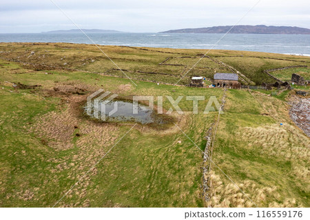 Aerial view of the Inishkeel island during a misty and hazy winter day - Portnoo, County Donegal, Ireland Aerial view of the Inishkeel island during a misty and hazy winter day - Portnoo, County Donegal, Ireland 116559176