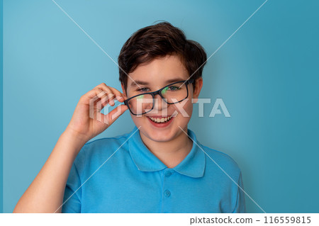 A funny happy handsome boy, dark-haired, wearing lopsided glasses and a blue T-shirt, A funny happy handsome boy, dark-haired, wearing lopsided glasses and a blue T-shirt, 116559815