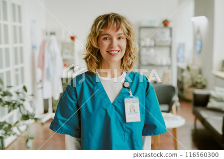 Portrait of blonde nurse looking at camera directly and smiling widely showing her teeth 116560300