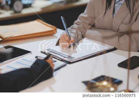 Judge gavel with Justice lawyers having team meeting at law firm background. Concepts of Law and Legal services. 116560975