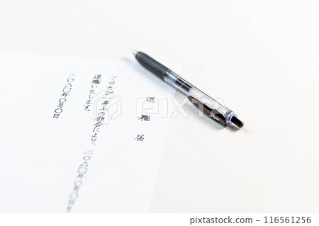 A handwritten resignation letter and a black gel ink pen on a white table A handwritten resignation letter and a black gel ink pen on a white table 116561256