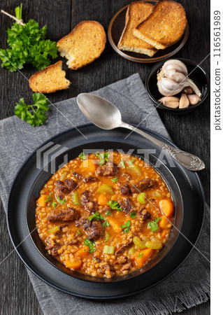 beef barley soup in a bowl, top view beef barley soup in a bowl, top view 116561989