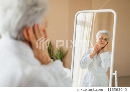 Love yourself. Beautiful old woman enjoying mirror reflection. Senior older lady spending morning in bathroom looking at mirror confident happy. Woman doing daily morning beauty routine. Self love Love yourself. Beautiful old woman enjoying mirror reflection. Senior older lady spending morning in bathroom looking at mirror confident happy. Woman doing daily morning beauty routine. Self love 116563043