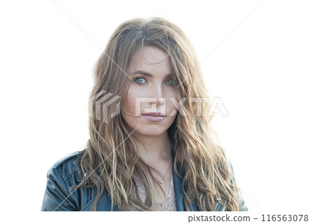 Isolated young adult female model with windy brown hair walking outdoor 116563078