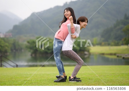 Two women doing stretching exercises 116563806
