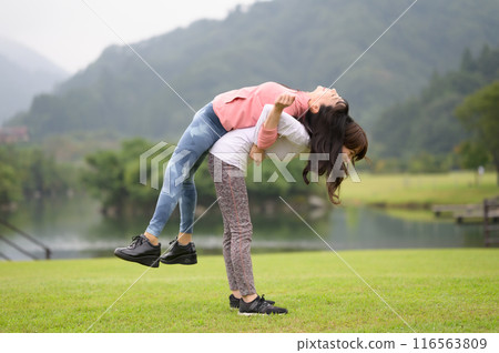 Two women doing stretching exercises 116563809