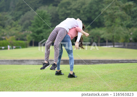 Two women doing stretching exercises 116563823