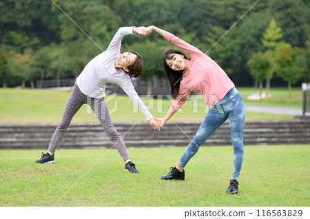 Two women doing stretching exercises 116563829