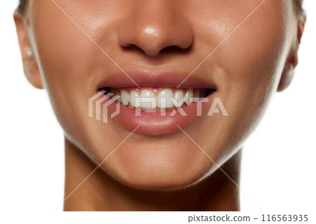 Cropped image of female face, nose, lips and teeth isolated on white background. Teeth whitening, dental care 116563935