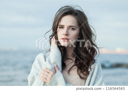 Nice healthy brunette woman with long hairstyle and fresh skin walking outdoors 116564565
