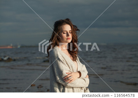 Relaxing healthy brunette woman with long hairstyle and fresh skin walking outdoors Relaxing healthy brunette woman with long hairstyle and fresh skin walking outdoors 116564578