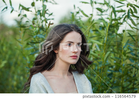 Young adult healthy brunette woman with long hairstyle and fresh skin walking outdoors Young adult healthy brunette woman with long hairstyle and fresh skin walking outdoors 116564579