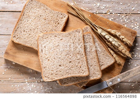 Healthy wholemeal bread slices on rustic wooden table. Healthy wholemeal bread slices on rustic wooden table. 116564898